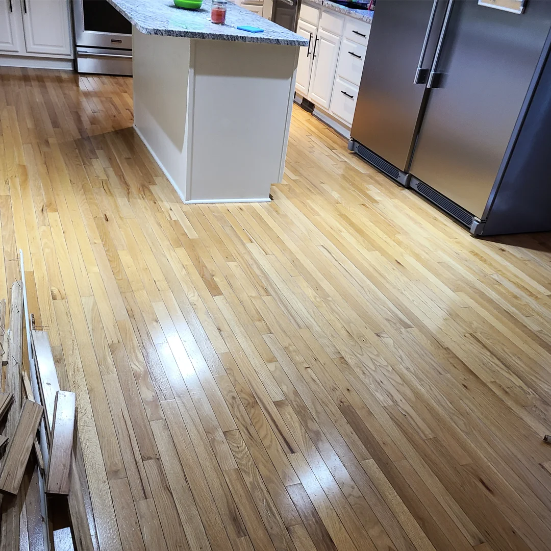 Newly finished glossy hardwood floor in a kitchen