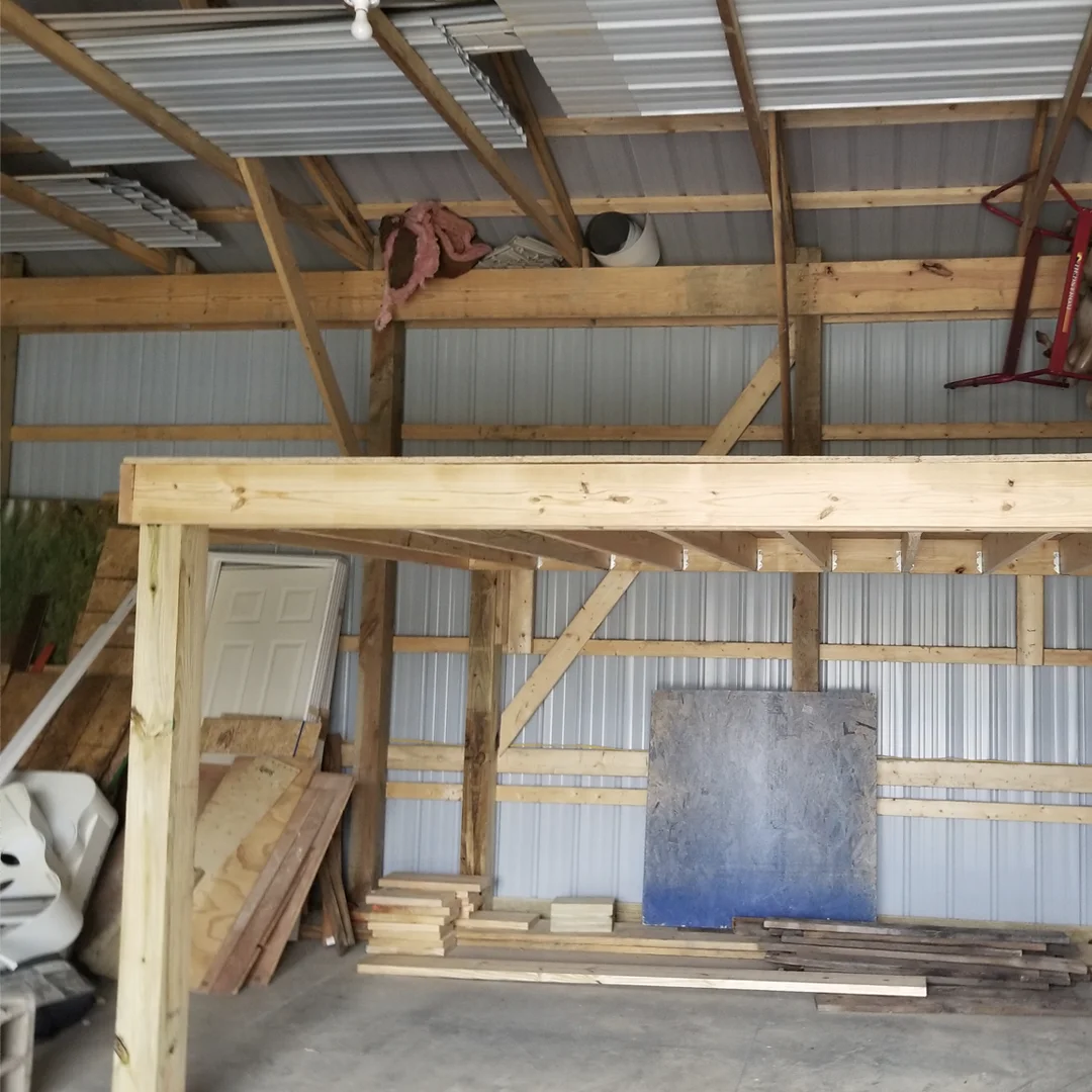 Interior wood framing going up inside a metal pole barn