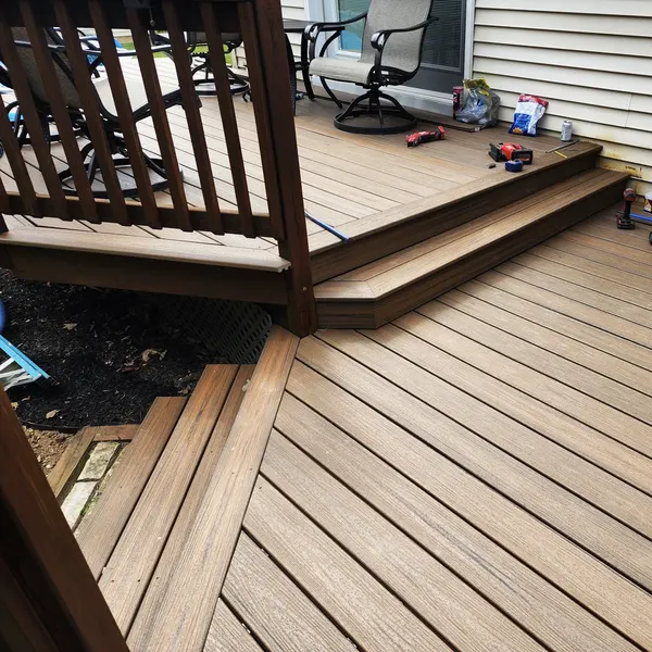 Composite deck with two-tone boards and dark railing