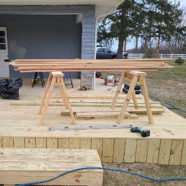 Pressure-treated front porch deck under construction