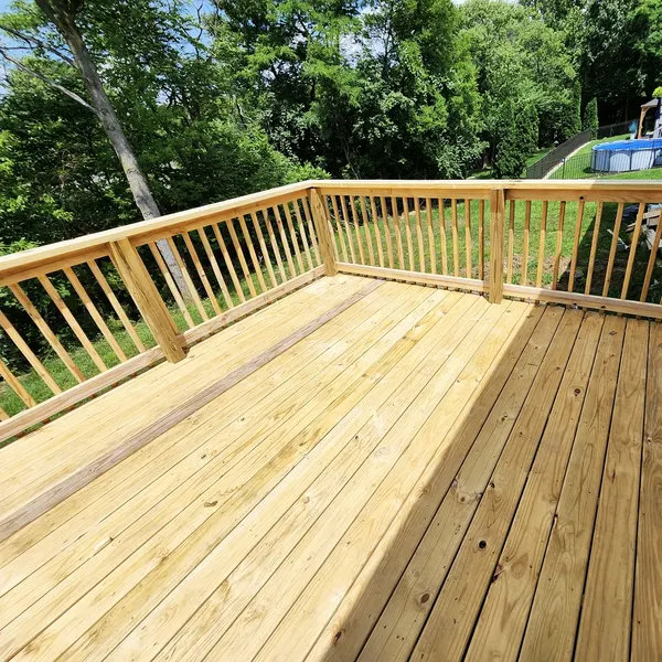 Large pressure-treated deck with spindle railing