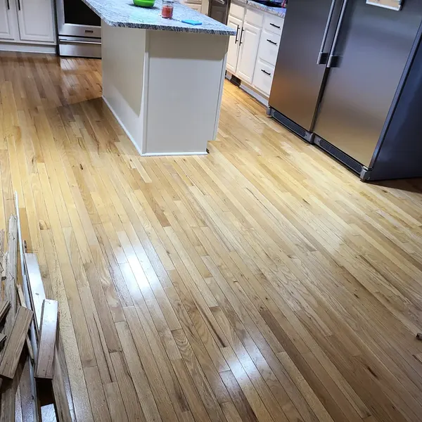 Newly finished glossy hardwood floor in a kitchen