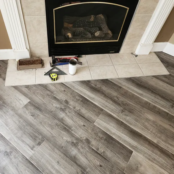Wood-look vinyl plank flooring in front of a fireplace