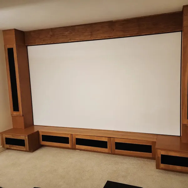 Home theater with projection screen and wood-trimmed platform