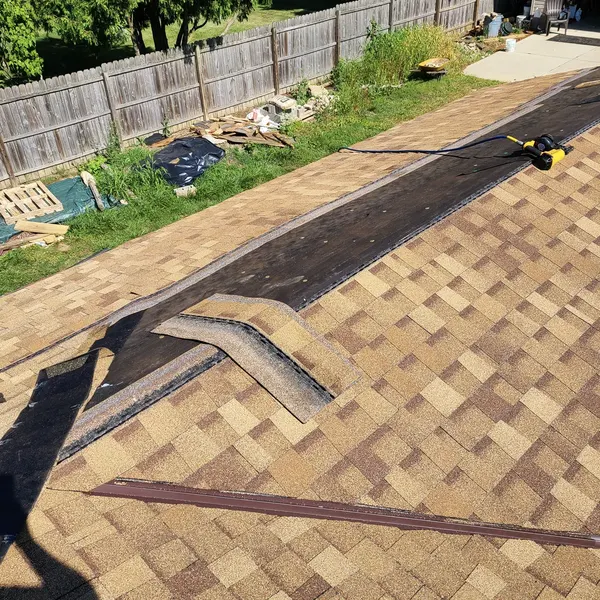 New architectural asphalt shingles being installed on a roof